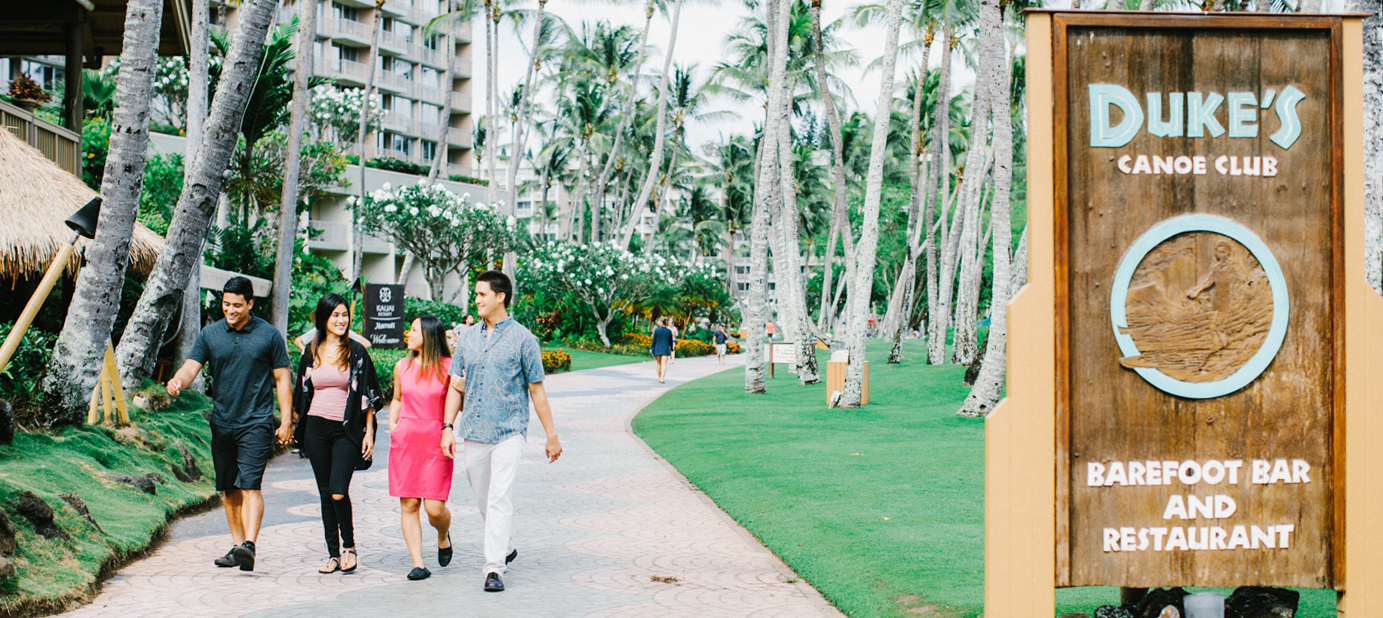 Group of friends walking outside of Duke's Kauai