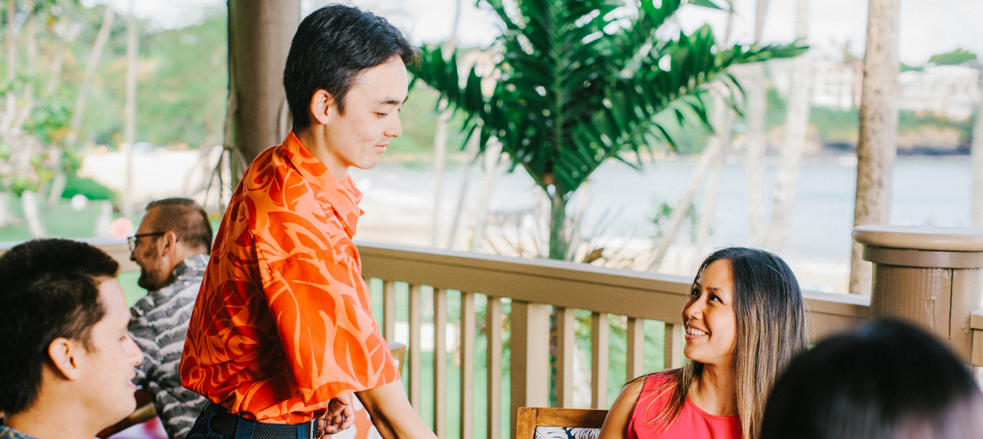 Waiter presenting food to a guest